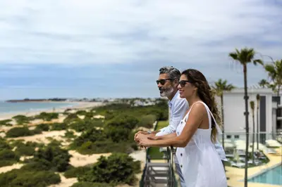 a row of white chairs in a room at Hipotels Barrosa Park in Chiclana de la Frontera