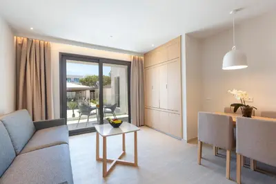 a hotel room with a bed and a desk with a view at Hipotels Barrosa Park in Chiclana de la Frontera