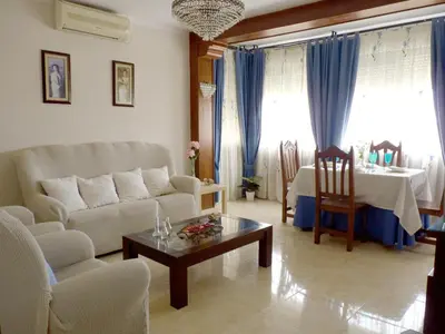 a living room with a couch and a table at Playa de la Calzada in Sanlúcar de Barrameda