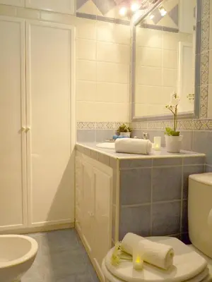 a bathroom with a sink and a toilet and a mirror at Playa de la Calzada in Sanlúcar de Barrameda