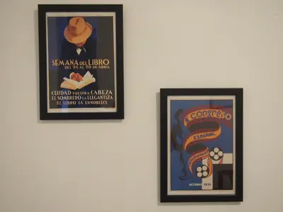 two framed posters hanging on a wall at Casa Valientes A - Parking privado gratis & patio interior in Jerez de la Frontera