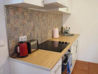 a small kitchen with a counter and a sink at Casa Valientes A - Parking privado gratis & patio interior in Jerez de la Frontera