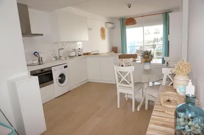 a kitchen and dining room with a table and a dining room at Villa Horacia in Sanlúcar de Barrameda