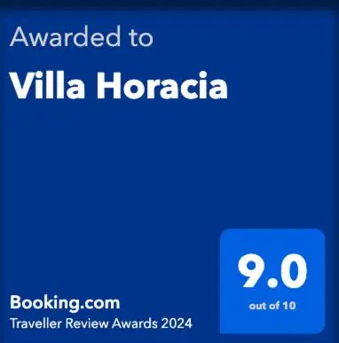 a blue sign with the words awarded to villa honda at Villa Horacia in Sanlúcar de Barrameda