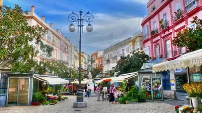 a city street with people walking through a market at Apartamento del Mercado Little Apartments in Cádiz