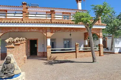 a statue sitting in front of a building at Chalet Pradillo in Conil de la Frontera