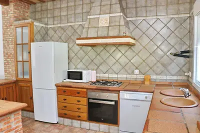 a kitchen with a white refrigerator and a microwave at Chalet Pradillo in Conil de la Frontera