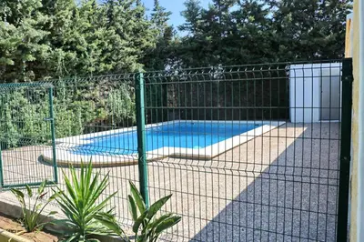 a fence around a swimming pool in a yard at Chalet Pradillo in Conil de la Frontera