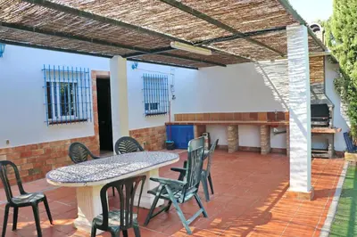 a patio with a table and chairs at Chalet Pradillo in Conil de la Frontera
