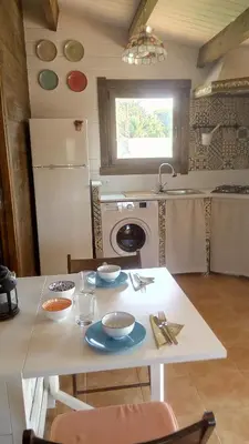 a kitchen with a table with bowls and plates on it at El Vivero in Chiclana de la Frontera