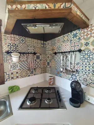 a stove top in a kitchen with tiles on the wall at El Vivero in Chiclana de la Frontera