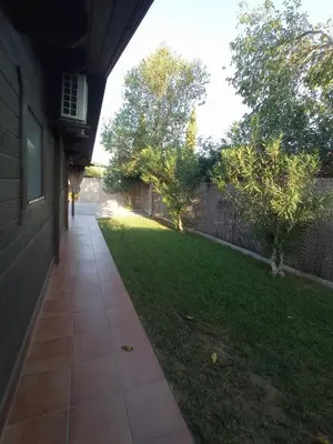a walkway in front of a house with a yard at El Vivero in Chiclana de la Frontera
