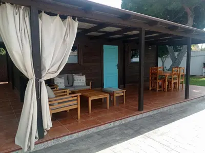 a pavilion with a table and chairs on a patio at El Vivero in Chiclana de la Frontera