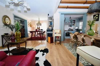 a living room with a cow laying on the floor at Villa Cai in Chiclana de la Frontera