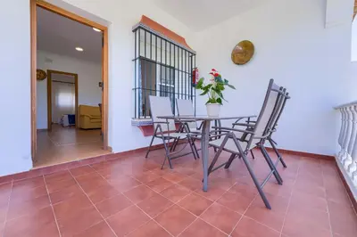 a dining room with a table and chairs at Hostal del Faro in Conil de la Frontera