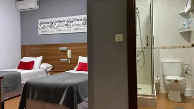 a hospital room with two beds and a toilet at Hostal San Francisco in Cádiz