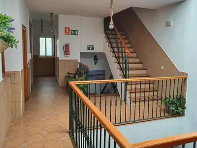 an empty hallway with a staircase in a building at Hostal Canalejas in Cádiz
