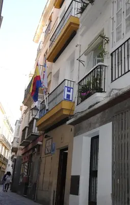 a building with balconies on a city street at Hostal Canalejas in Cádiz
