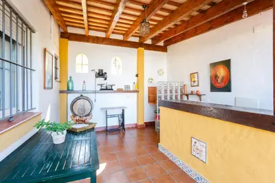 a large room with a counter and a kitchen at Bonito Chalet Con Vistas in Sanlúcar de Barrameda