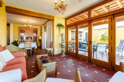a living room with a red couch and chairs at Bonito Chalet Con Vistas in Sanlúcar de Barrameda