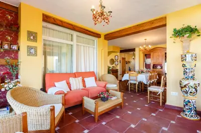 a living room with a couch and a table at Bonito Chalet Con Vistas in Sanlúcar de Barrameda