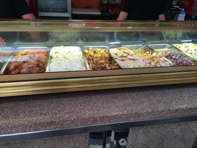 a display case filled with lots of different types of food at Hotel La Parrita in Rota