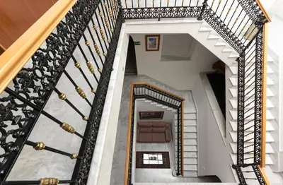 an attic staircase with black and white railings at Hotel La Parrita in Rota
