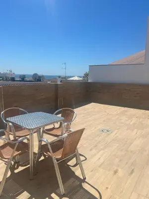 a table and chairs sitting on a patio at Hotel La Parrita in Rota