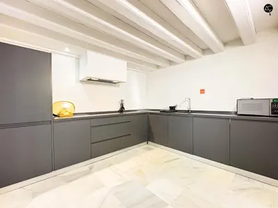 a kitchen with gray cabinets and a microwave at Casa Columela Cádiz Grupo AC Gestión in Cádiz