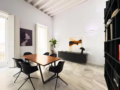 a dining room with a wooden table and chairs at Casa Columela Cádiz Grupo AC Gestión in Cádiz