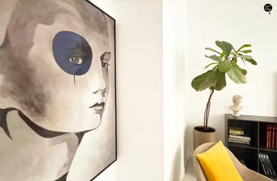 a painting of a woman on a wall in a living room at Casa Columela Cádiz Grupo AC Gestión in Cádiz