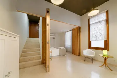 a hallway with a staircase and a room with a bed at Casa en Plaza de la Merced_Centro Flamenco_Cádiz in Cádiz