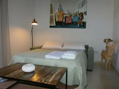 a bedroom with a bed with a table and a picture at Casa en Plaza de la Merced_Centro Flamenco_Cádiz in Cádiz