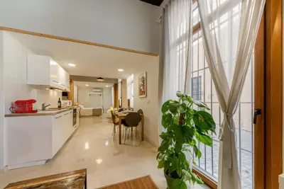 a kitchen and living room with a large window at Casa en Plaza de la Merced_Centro Flamenco_Cádiz in Cádiz