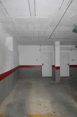 an empty room with white doors and a red and white wall at Piso Aurora in Sanlúcar de Barrameda