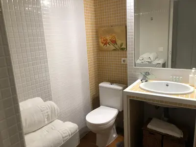 a bathroom with a white toilet and a sink at Apartamento La Mar de Cerca. Terraza vistas Mar. 1ª Linea Playa in Cádiz