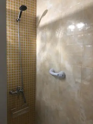 a shower with a shower head in a bathroom at Apartamento La Mar de Cerca. Terraza vistas Mar. 1ª Linea Playa in Cádiz