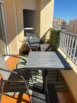 a balcony with a table and chairs on a balcony at Apartamento La Mar de Cerca. Terraza vistas Mar. 1ª Linea Playa in Cádiz