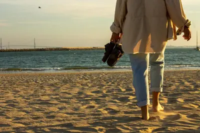a woman walking on the beach at TAIGA Puerto Santa María in El Puerto de Santa María