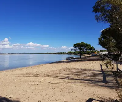 a sandy beach next to a body of water at Casa del Mar in Puerto Real