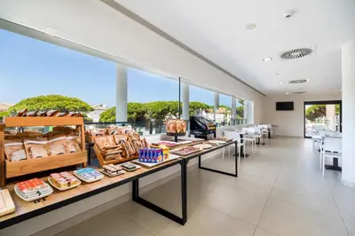 a bakery with a buffet of food on display at Complejo Al Sur - by Grupo Tribu in Chiclana de la Frontera