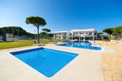 a swimming pool in front of a house at Complejo Al Sur - by Grupo Tribu in Chiclana de la Frontera