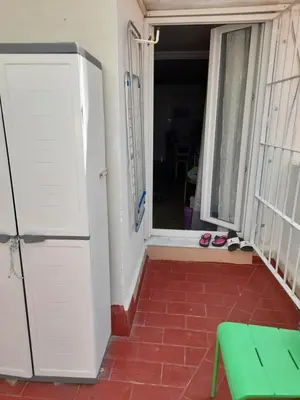 an open door to a room with a window and shoes at Estudio Carmen in Cádiz