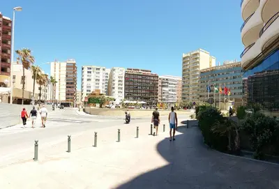 a group of people walking and riding bikes on a city street at Estudio Carmen in Cádiz