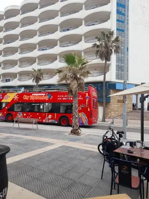 a red double decker bus parked in front of a building at Estudio Carmen in Cádiz