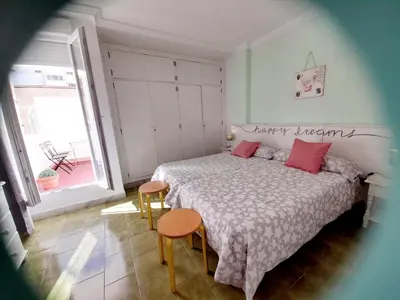 a bedroom with a bed with red pillows on it at Estudio Carmen in Cádiz