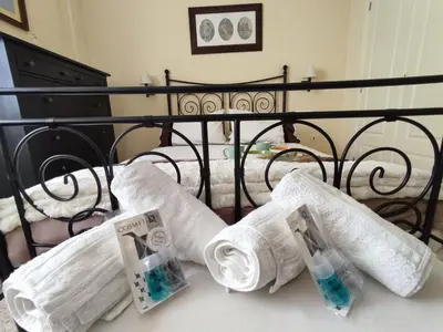 a bed with two rolls of toilet paper on it at ÁTICO TERRAZA 65m. Playa, piscina, A/C, Wifi in Sanlúcar de Barrameda
