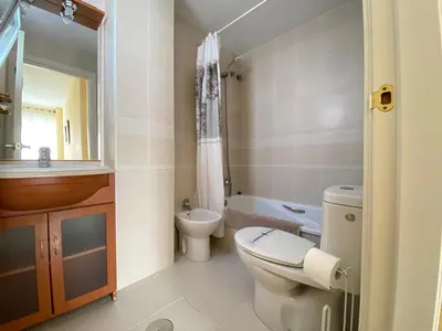 a bathroom with a toilet and a sink at ÁTICO TERRAZA 65m. Playa, piscina, A/C, Wifi in Sanlúcar de Barrameda