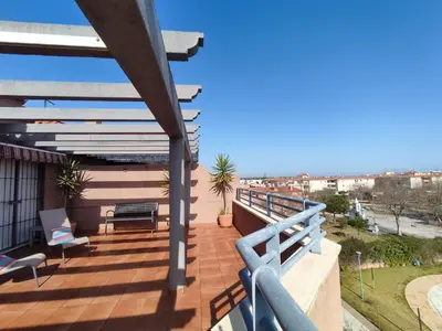 a balcony of a house with a blue railing at ÁTICO TERRAZA 65m. Playa, piscina, A/C, Wifi in Sanlúcar de Barrameda