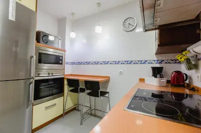 a kitchen with a stove and a counter top at Apartamento El Patio de Canovas in Cádiz